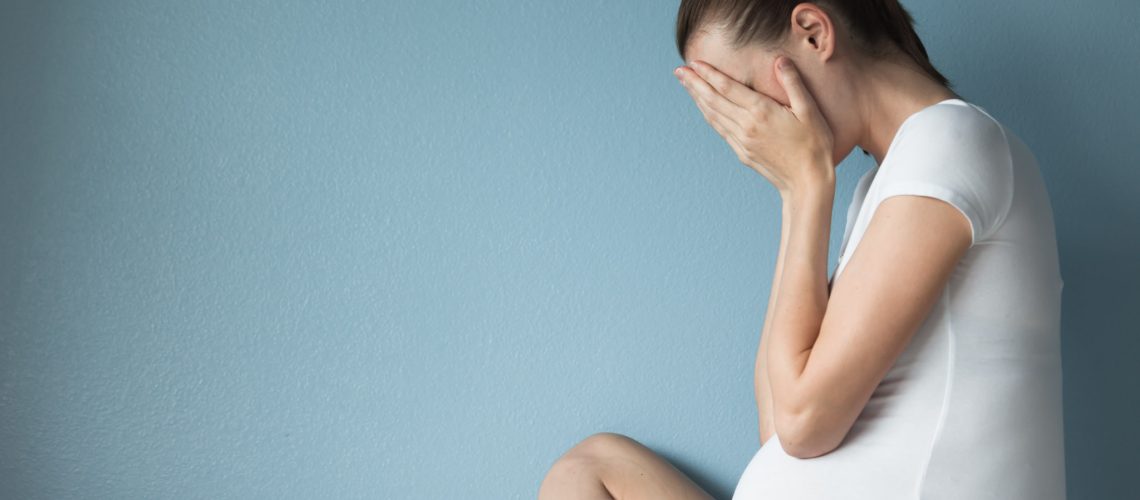 Portrait of sad and frustrated pregnant woman.